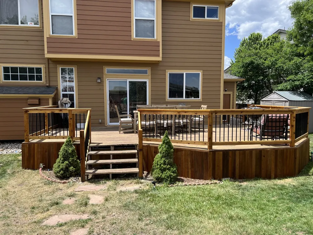 Davidson deck after: stained wood, new handrails with black balusters and solid skirting