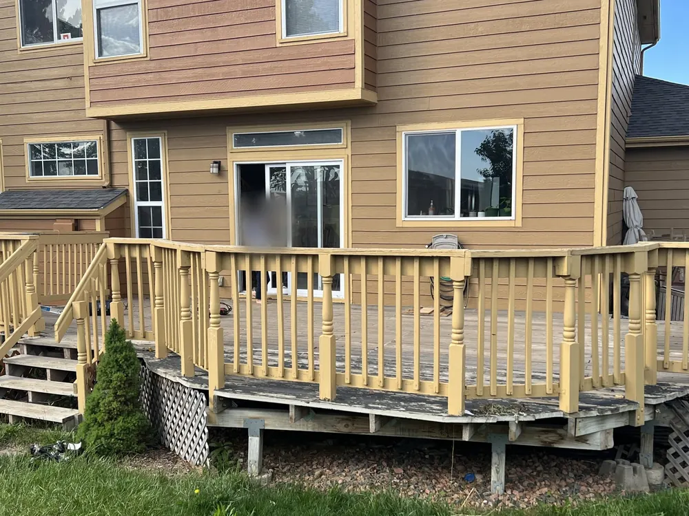 Davidson deck before: faded yellow paint, worn gray boards and lattice skirting