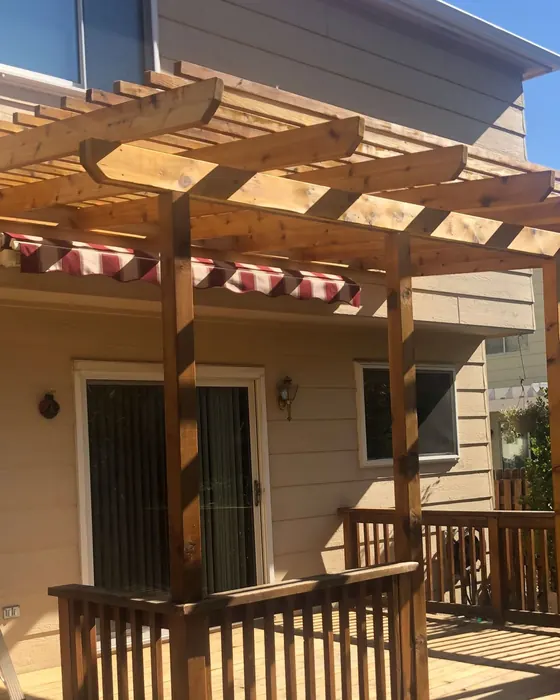 New cedar pergola over a raised deck with stairs