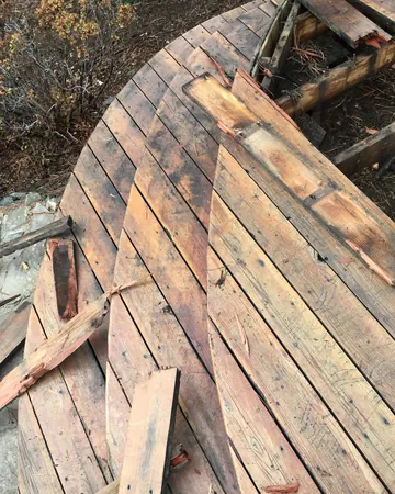 Weathered, split boards on the old curved deck in Genesee before the rebuild
