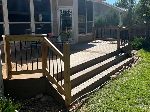 Phipps deck after: rebuilt deck with new stairs and cedar handrails with black balusters