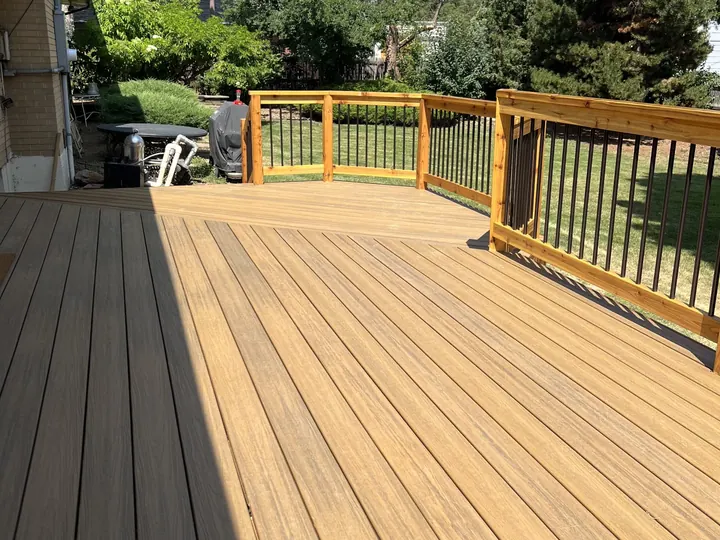 New deck boards and cedar handrails with black balusters on the rebuilt Richard deck